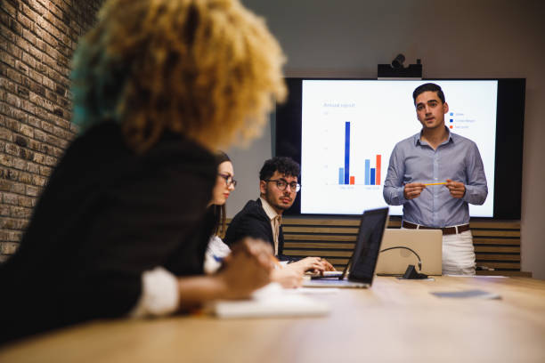 istock Businessman leading a meeting, discussing data with a coworker 1385088070