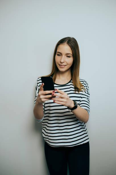 istock young women using the phone in studio 1385088910