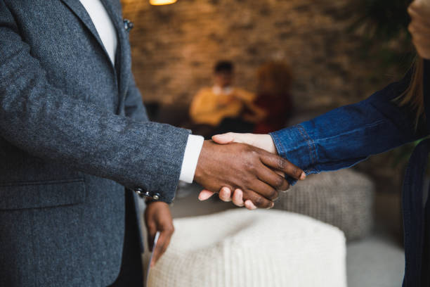 istock Unrecognizable Black businessman shaking White colleague's hand when meeting 1385089422