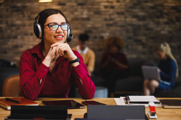istock Female customer service agent smiling during a call with a customer 1385089511