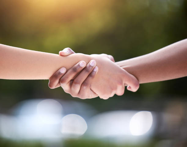 istock Shot of two unrecognizable people holding hands outside 1385090168