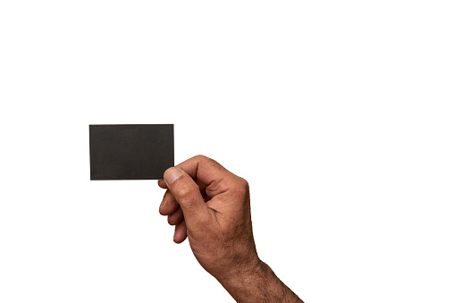male hand holding blank  black business card mock up against white background ,copy space .