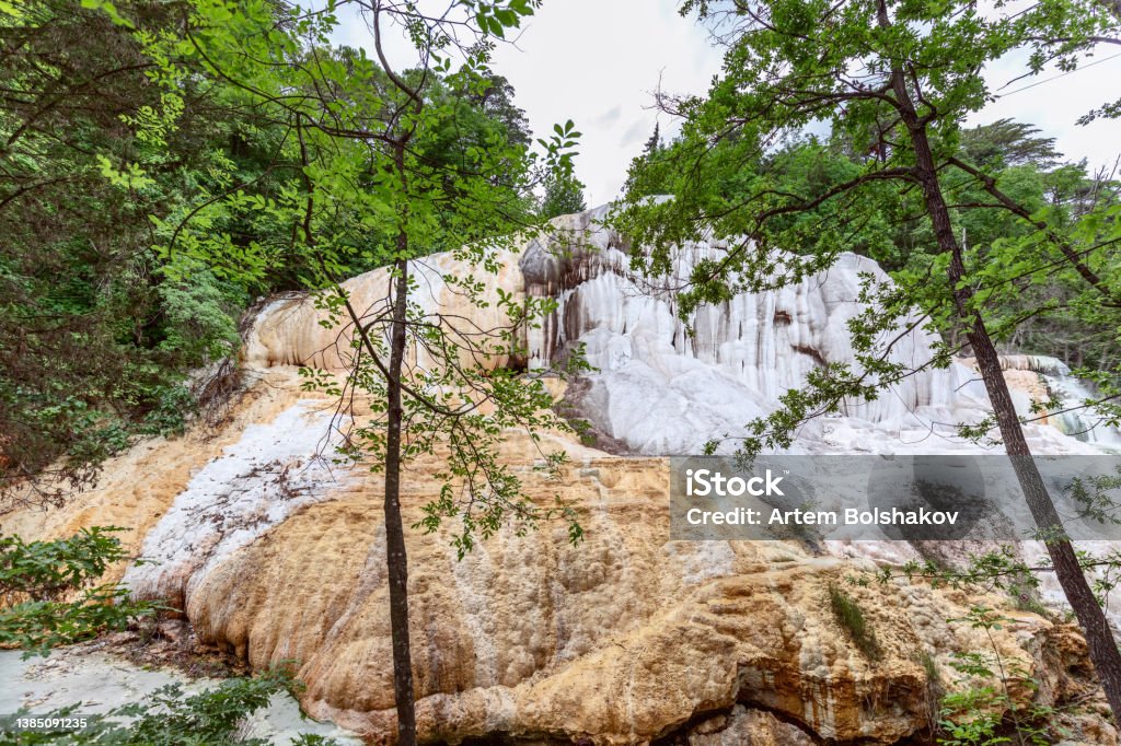 The White Whale rock in Bagni San Filippo are covered with white stalactites and stalagmites from thermal water. Tuscany, Italy Calcium Stock Photo