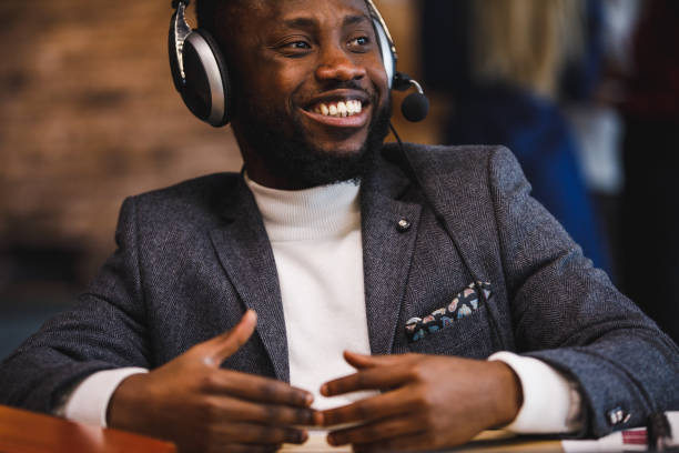 istock Black businessman in a headset having a conference call 1385091834