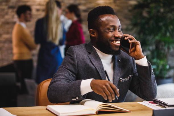 istock Cheerful businessman on a conference call, smiling and looking away 1385091849