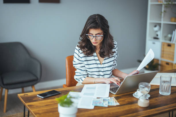 Finance and economics Serious frustrated middle-aged businesswoman worried about reading bad news, stressed anxious mature lady who has problems with household bills, worried about bankrupt debts and money. The concept of finance and economics counting stock pictures, royalty-free photos & images