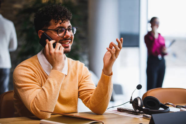 istock Hipster businessman on a conference call gesturing 1385092133