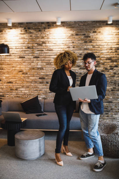 istock Two business people looking at data on laptop at the office lobby 1385093216