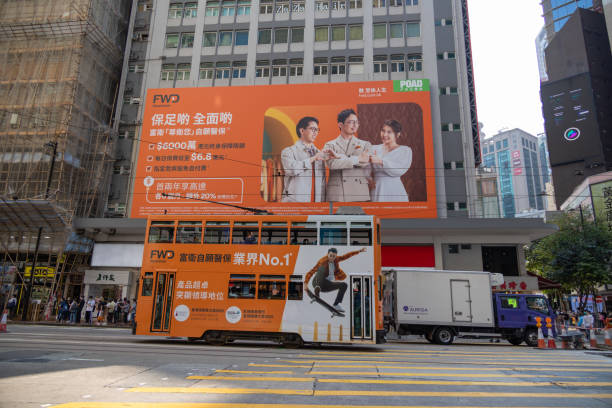 Hong Kong - March 14, 2022 : A billboard and a double-decker tram for the FWD Group in Causeway Bay, Hong Kong.
