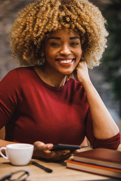 istock Cheerful businesswoman using smart phone, smiling at camera 1385093903