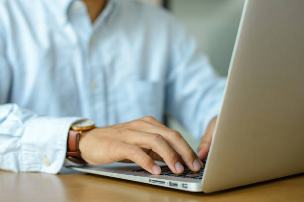 istock Young businessman working with laptop computer on desk. 1385093909