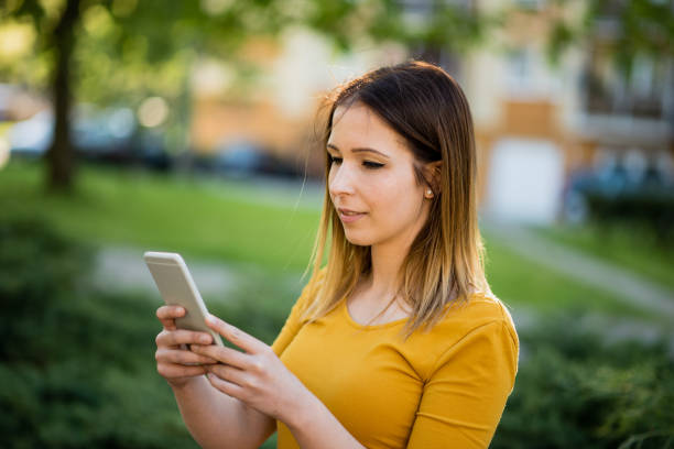istock women using smart phone in city 1385095082
