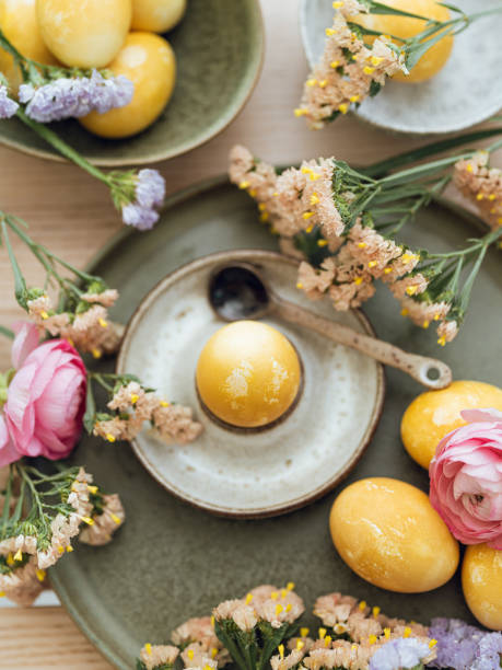 istock Yellow natural colored easter egg and flowers arrangement 1385095087