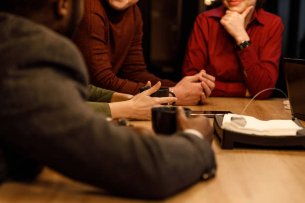 istock Small group of unrecognizable business colleagues chatting during coffee break 1385095109