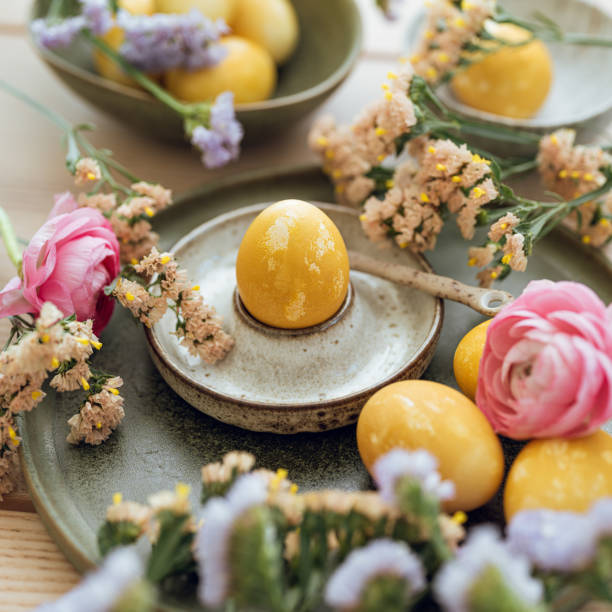 istock Yellow natural colored easter egg and flowers arrangement 1385095188