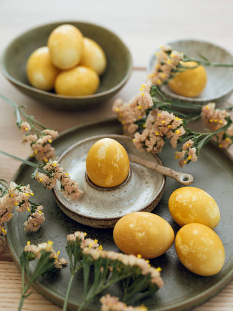 istock Yellow natural colored easter egg and flowers arrangement 1385095220