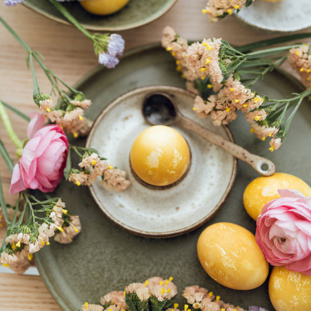 istock Yellow natural colored easter egg and flowers arrangement 1385095349