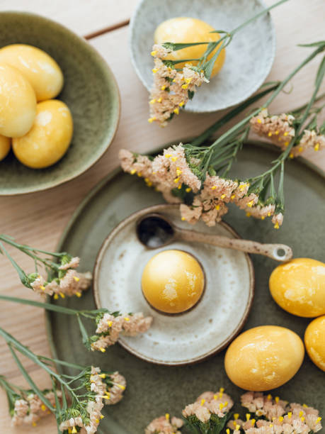 istock Yellow natural colored easter egg and flowers arrangement 1385095908