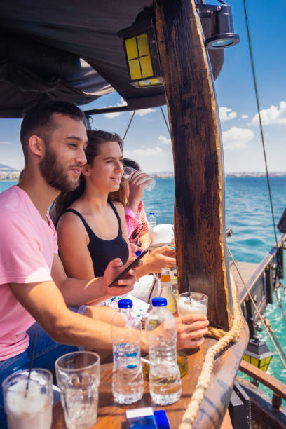 istock Two friends hanging out, talking and drinking coffee on a boat 1385095916