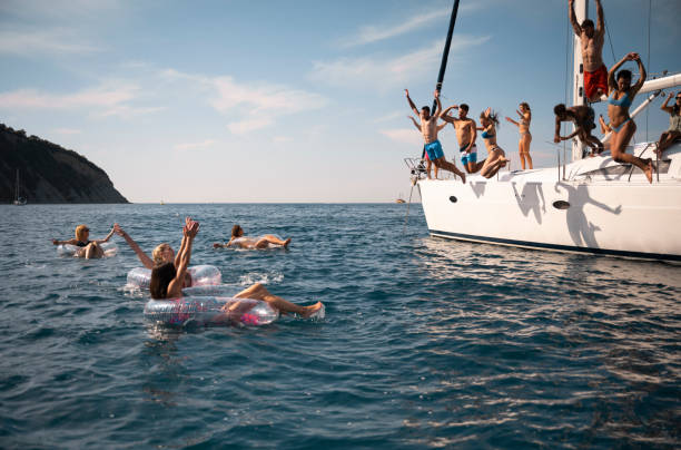 istock Friends jumping in sea 1385096023
