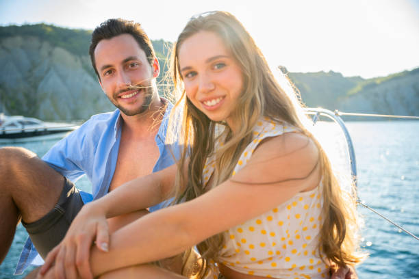 istock Happy couple sitting on sail boat 1385096026