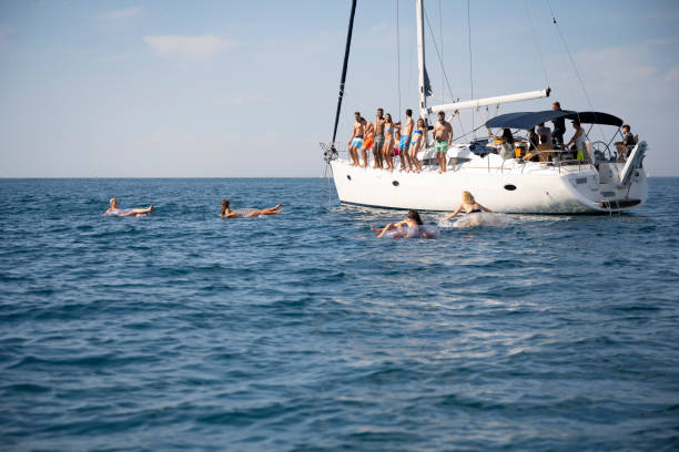 istock Friends standing on sailboat 1385096029