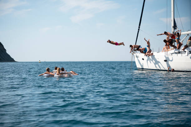 istock Friends jumping in sea 1385096051