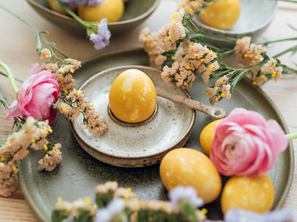 istock Yellow natural colored easter egg and flowers arrangement 1385096091