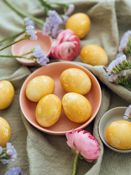istock Yellow natural colored easter egg and flower arrangement 1385096666