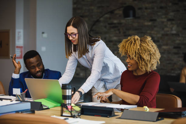 istock Discussing project data they are reviewing on a laptop 1385096716