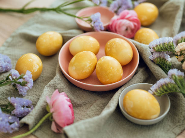 istock Yellow natural colored easter egg and flower arrangement 1385096732