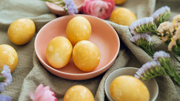 istock Yellow natural colored easter egg and flower arrangement 1385096809