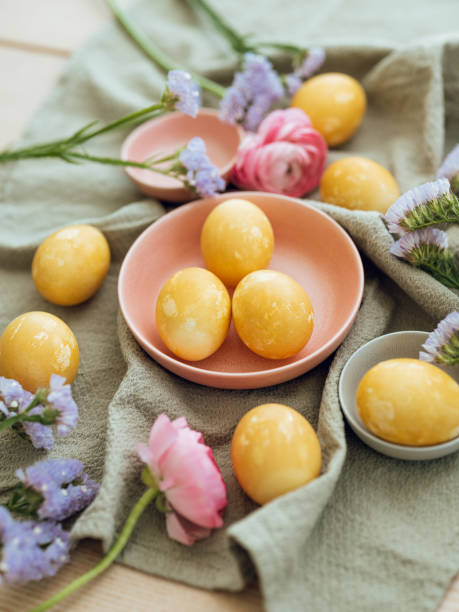 istock Yellow natural colored easter egg and flower arrangement 1385096885