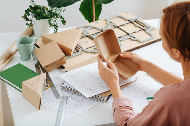 istock Woman holding a box in hands, thinking process on ways to improve it. 1385096915