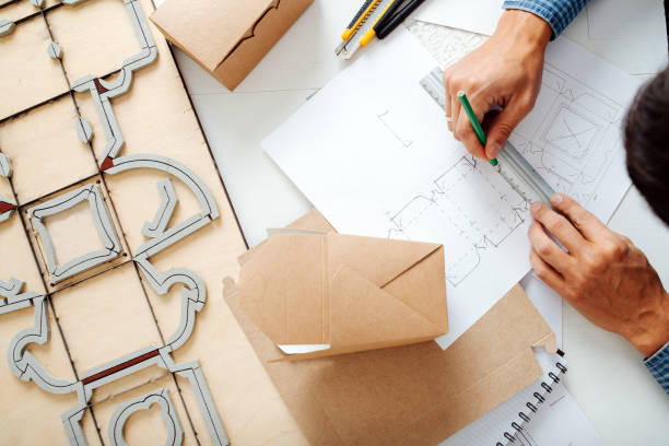 istock Diligent box designer making a sketch on paper. Hands only,no face 1385096923