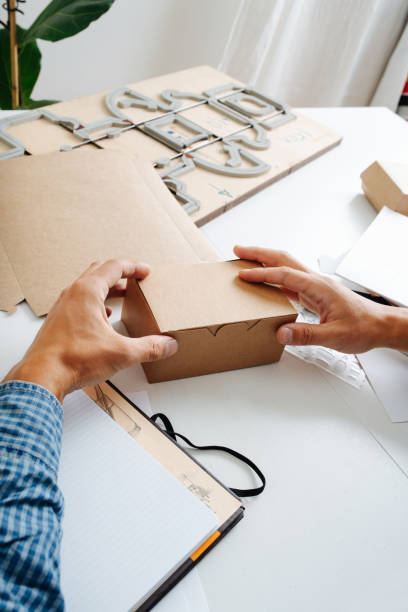 istock Man hands holding a box in hands, thinking process on ways to improve it. 1385096926