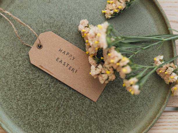 istock Flowers and ceramic with tag with text happy easter 1385097161