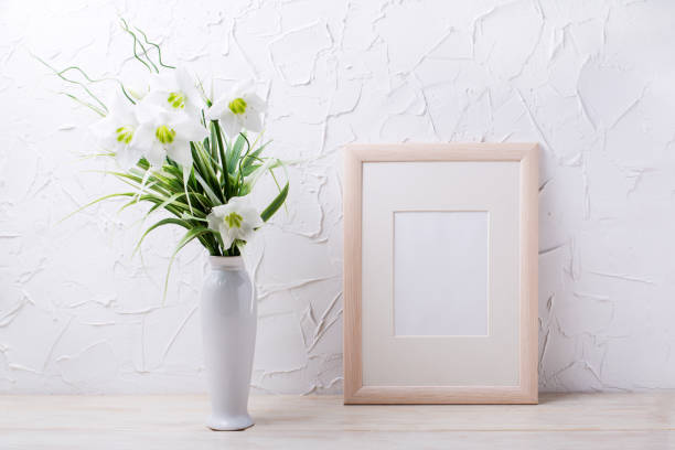 istock Wooden frame mockup with lily in the white vase 1385097258