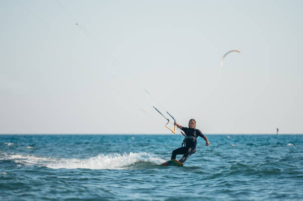 istock Woman kitesurfing on the ocean waters 1385097462