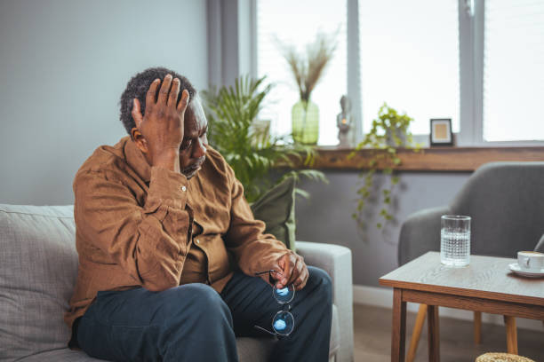 istock Thoughtful senior man sitting on couch 1385099295