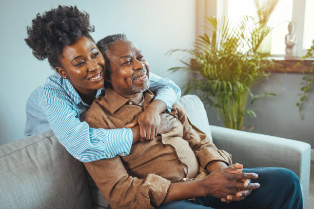 istock Loving father and daughter together on sofa. 1385099602