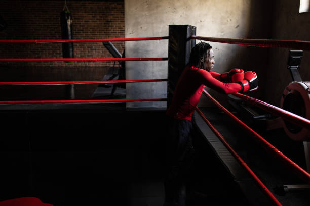istock Side view of young male boxer Black ethnicity in the boxing ring 1385100607