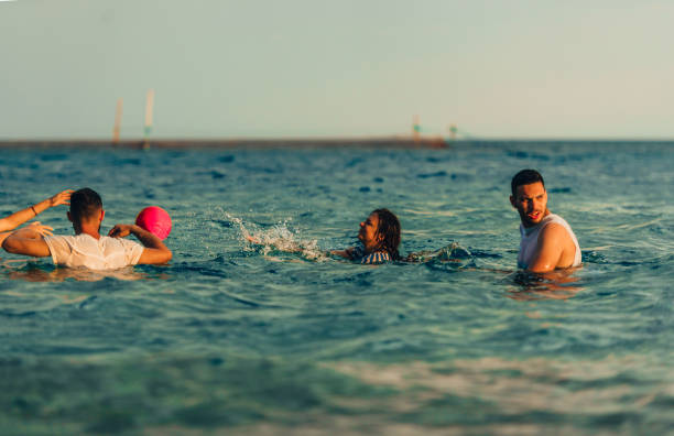 istock Four friends training together in the water with ball 1385101074