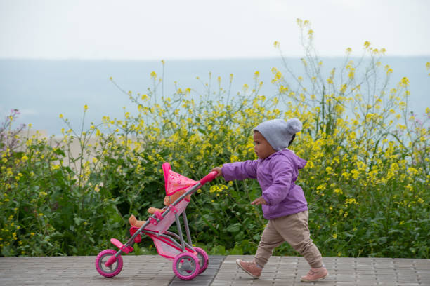 A young boy sits on a ride-on toy car in an outdoor setting, symbolizing childhood fun and happy moments. A child aged 3 years