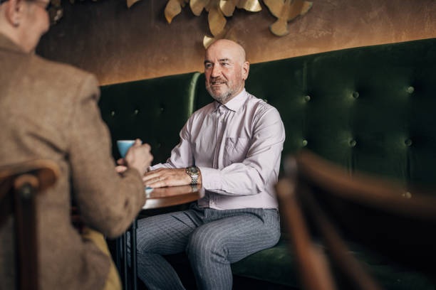 istock Man interviewing a woman in cafe 1385101392