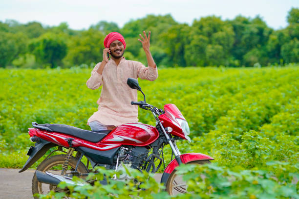 istock Indian farmer talking on smartphone at agriculture field. 1385102564