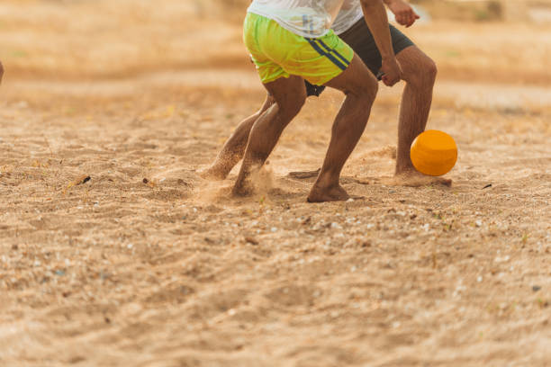 istock Friends playing on the sand beach 1385102583