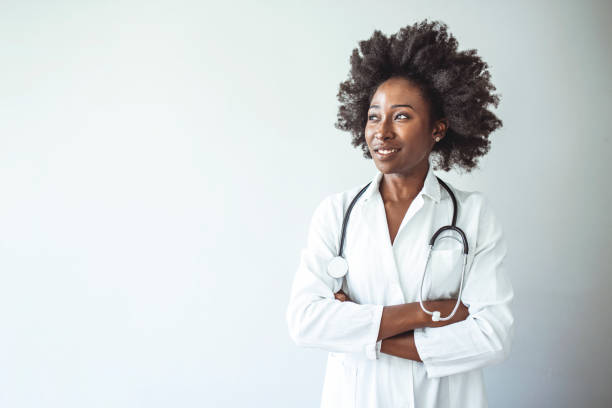 istock Woman hospital worker looking at camera and smiling 1385105154