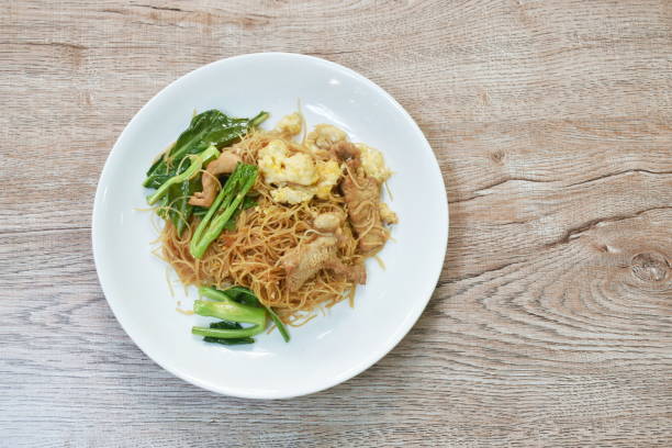 istock stir fried vermicelli thin rice noodles with slice fermenting pork and Chinese kale dressing black sweet soybean sauce 1385105215