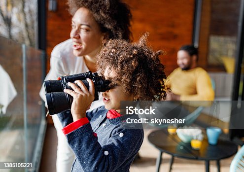istock Happy African American mother and daughter enjoying on a balcony. 1385105221